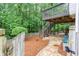 Landscaped backyard featuring a wooden deck with stairs, stone patio, and lush greenery, ideal for outdoor living at 2122 Rockland Ct, Marietta, GA 30062