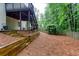 Large backyard with wooden retaining wall, lush greenery, and a charming arbor, perfect for outdoor relaxation at 2122 Rockland Ct, Marietta, GA 30062