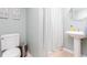 Cozy, bright bathroom with pedestal sink, blue and white striped curtain and tile flooring at 2122 Rockland Ct, Marietta, GA 30062
