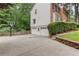 Spacious driveway with a three-car garage, basketball hoop, and landscaped greenery offering ample parking and curb appeal at 2122 Rockland Ct, Marietta, GA 30062