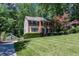 A two-story brick home featuring black shutters, a manicured lawn, and a driveway with a basketball hoop at 2122 Rockland Ct, Marietta, GA 30062