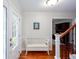 Inviting foyer with hardwood floors, staircase, and a decorative white bench at 2122 Rockland Ct, Marietta, GA 30062