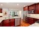 Bright kitchen with stainless steel appliances, granite counters, and custom cabinetry at 2122 Rockland Ct, Marietta, GA 30062