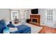Comfortable living room with a brick fireplace, a large window, and a blue sofa at 2122 Rockland Ct, Marietta, GA 30062