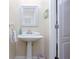 Powder room featuring a pedestal sink, neutral walls, and a white framed mirror at 2122 Rockland Ct, Marietta, GA 30062