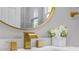 Bright bathroom featuring gold fixtures, round mirror, and fresh white floral arrangement at 2453 Paul Nw Ave, Atlanta, GA 30318