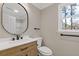 Well-lit bathroom featuring wood vanity with black hardware and modern fixtures at 2453 Paul Nw Ave, Atlanta, GA 30318