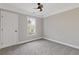Clean bedroom with neutral carpet, ceiling fan, and trim at 2453 Paul Nw Ave, Atlanta, GA 30318
