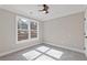 Empty bedroom with neutral carpet, large window, ceiling fan, and ample natural light at 2453 Paul Nw Ave, Atlanta, GA 30318