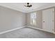 Neutrally painted bedroom featuring a ceiling fan, window, and carpeted floors at 2453 Paul Nw Ave, Atlanta, GA 30318