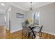 Modern dining room with hardwood floors, a black dining set, and contemporary lighting at 2453 Paul Nw Ave, Atlanta, GA 30318