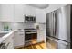 Updated kitchen featuring stainless steel appliances, white cabinets, and hardwood floors at 2453 Paul Nw Ave, Atlanta, GA 30318