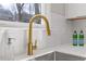 Close up on a Stainless steel sink with quartz countertops and a gold faucet at 2453 Paul Nw Ave, Atlanta, GA 30318