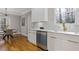 Updated kitchen with stainless steel appliances, dishwasher, white cabinets, and modern lighting at 2453 Paul Nw Ave, Atlanta, GA 30318