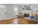 Cozy living room with a fireplace, hardwood floors, and natural light from the large window at 2453 Paul Nw Ave, Atlanta, GA 30318