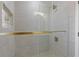 Modern tiled shower featuring glass door and gold hardware at 2453 Paul Nw Ave, Atlanta, GA 30318