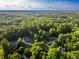 A bird's eye view of the area shows lush greenery and multiple houses at 4085 Fawn Valley Dr, Loganville, GA 30052
