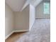 Attic space featuring angled walls and neutral carpet at 4085 Fawn Valley Dr, Loganville, GA 30052