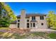 Back exterior showing a patio and lush greenery with a two-car garage at 4085 Fawn Valley Dr, Loganville, GA 30052