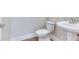 Powder room features a pedestal sink and white fixtures at 4085 Fawn Valley Dr, Loganville, GA 30052