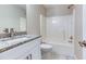Bathroom featuring a granite vanity and a white shower-tub combo at 4085 Fawn Valley Dr, Loganville, GA 30052