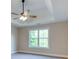Bedroom featuring tray ceilings, a ceiling fan, and a window view at 4085 Fawn Valley Dr, Loganville, GA 30052