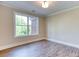 Bright bedroom featuring a large window and neutral walls, complete with modern flooring at 4085 Fawn Valley Dr, Loganville, GA 30052