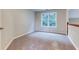 Bedroom with a large window providing natural light and neutral colored walls at 4085 Fawn Valley Dr, Loganville, GA 30052