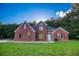 Stunning brick home featuring a well-maintained lawn and symmetrical design, set against a treed backdrop at 4085 Fawn Valley Dr, Loganville, GA 30052