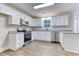 Kitchen features white cabinets, stainless steel appliances and granite countertops at 4085 Fawn Valley Dr, Loganville, GA 30052