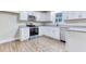 Bright kitchen features white cabinets, stainless steel appliances, and granite countertops at 4085 Fawn Valley Dr, Loganville, GA 30052