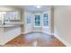 Kitchen features a breakfast nook, white cabinets, granite countertops, and hardwood floors at 4085 Fawn Valley Dr, Loganville, GA 30052