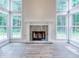 Living room featuring tall windows flanking a fireplace, showcasing elegant flooring and trim details at 4085 Fawn Valley Dr, Loganville, GA 30052