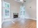 Bright living room with high ceilings, statement fireplace, and large windows overlooking serene greenery at 4085 Fawn Valley Dr, Loganville, GA 30052