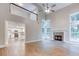 Spacious living room with high ceilings, fireplace, and abundant natural light flows to the open kitchen at 4085 Fawn Valley Dr, Loganville, GA 30052