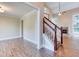 Inviting living room showcasing hardwood floors, staircase, and a cozy fireplace as focal point at 4085 Fawn Valley Dr, Loganville, GA 30052