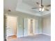 Bright main bedroom features tray ceilings, neutral walls, an ensuite bathroom and large windows at 4085 Fawn Valley Dr, Loganville, GA 30052