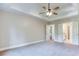 Spacious main bedroom with tray ceiling, ceiling fan, neutral walls, and access to ensuite bathroom at 4085 Fawn Valley Dr, Loganville, GA 30052