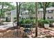 Charming townhome exterior with a patio set among mature trees and lush landscaping at 1750 Clairmont Rd # 35, Decatur, GA 30033