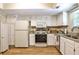 Bright kitchen with white cabinets, granite countertops, and stainless steel appliances at 1750 Clairmont Rd # 35, Decatur, GA 30033