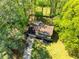 Overhead view of a beautiful home surrounded by mature trees and a large green lawn at 3719 Northbrook Ct, Atlanta, GA 30340