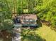 Aerial shot of home with a well-kept lawn, landscaping, and beautiful surrounding trees at 3719 Northbrook Ct, Atlanta, GA 30340