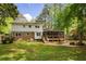 Spacious backyard featuring a screened-in porch, fire pit, and lush green lawn at 3719 Northbrook Ct, Atlanta, GA 30340