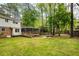 Secluded backyard with deck, fire pit, mature trees and lush grass, perfect for outdoor enjoyment at 3719 Northbrook Ct, Atlanta, GA 30340
