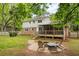 Spacious backyard with deck, fire pit and mature trees, perfect for entertaining or relaxing at 3719 Northbrook Ct, Atlanta, GA 30340