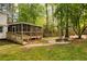 Large screened porch and backyard with a fire pit perfect for outdoor entertaining at 3719 Northbrook Ct, Atlanta, GA 30340
