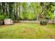 Large backyard with mature trees and storage shed, offering privacy and space at 3719 Northbrook Ct, Atlanta, GA 30340