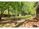 Secluded backyard features mature trees, fire pit, and shed, perfect for outdoor enjoyment at 3719 Northbrook Ct, Atlanta, GA 30340