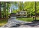 Charming two-story home with a large front yard, a two-car garage, and classic white exterior at 3719 Northbrook Ct, Atlanta, GA 30340