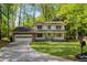 Charming two-story home with a brick garage, well-manicured lawn, and beautiful landscaping at 3719 Northbrook Ct, Atlanta, GA 30340